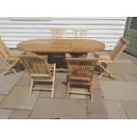 A new boxed teak garden table & 6 folding chairs. Table size extends from 150cm to 200cm with a 90cm