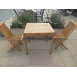 A new boxed teak bistro table 70cm x 70cm and two folding dining chairs.