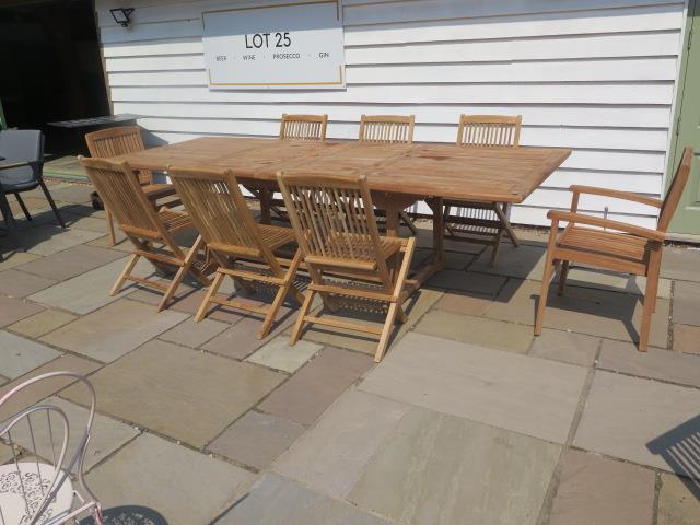 A new boxed teak garden table with 2 armchairs and 6 folding chairs with 2 foldout leaves, extends