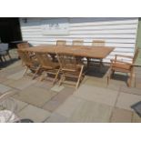 A new boxed teak garden table with 2 armchairs and 6 folding chairs with 2 foldout leaves, extends