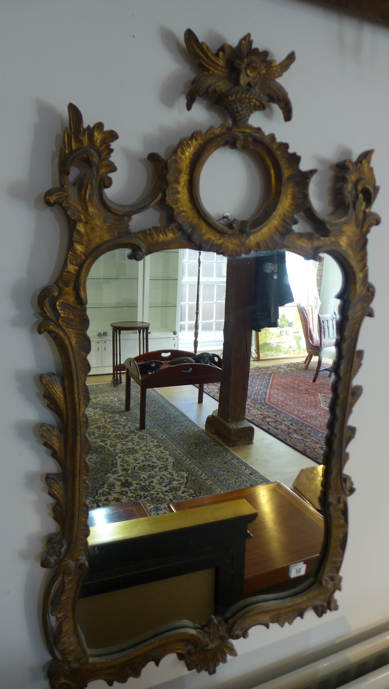 An ornate gilt mirror 105cm x 57cm
