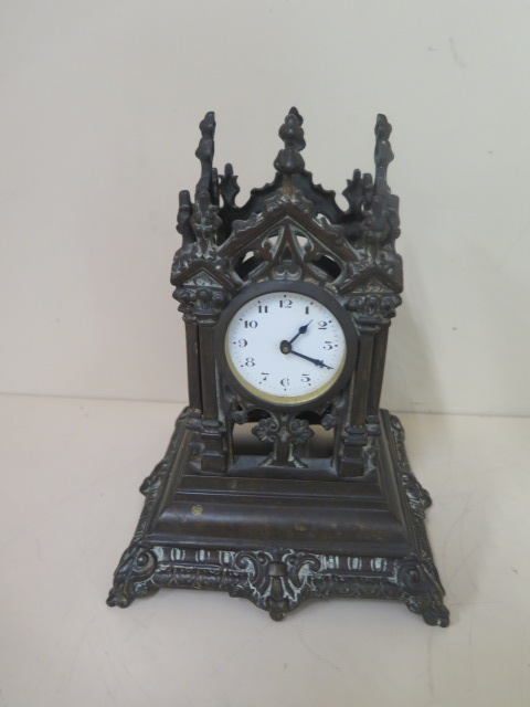 A bronze monument mantle clock, 21cm tall, movement appears overwound otherwise good condition