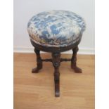 A Victorian walnut revolving piano stool, 49cm tall, restored and recovered.