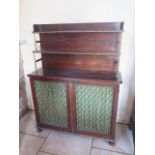 A Regency simulated rosewood chiffonier with a two tier top above 2 brass grillwork doors. 143 cm