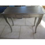 A silver painted side table with a drawer, 86 cm tall x 100 cm x 40 cm
