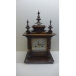 A 19th century Jonhams mantle clock 8-day movement strikes on gong. 47cmk tall, running in saleroom.