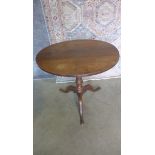 A Georgian oak tilt top side table on a tripod base. 68cm tall x 75cm diameter.