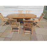 A new boxed teak garden table & 6 folding chairs. Table size extends from 150cm to 200cm with a