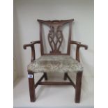 A carved oak chippendale style childs open armchair with upholstered seat 59cm tall, 45 cm wide,