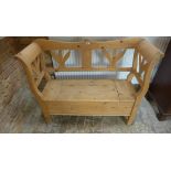 A continental stripped pine hall bench with a lift up seat. 95cm tall x 119cm wide x 39cm deep