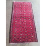 A hand knotted Baluchi rug. Size 1.94m x 1m