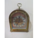 A good brass dome top striking mantle clock, 24cm tall, ticks but stops, with key
