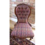 A reupholstered button back Victorian fireside chair