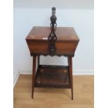 A pretty Edwardian rosewood inlaid basket workbox with a carry handle and 2 door lift uptop above