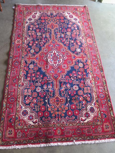 A hand knotted woollen Hamadan rug. Size 2.30m x 1.33m