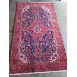 A hand knotted woollen Hamadan rug. Size 2.30m x 1.33m