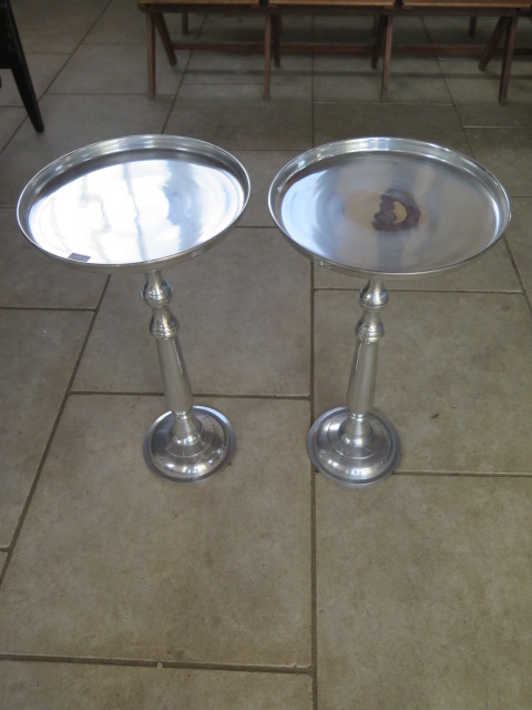 A pair of polished metal side tables, 66 cm tall x 35 cm