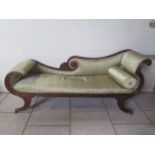 A good quality Regency rosewood scroll end chaise longue with reeded supports terminating in brass