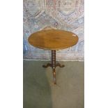 A 19th century mahogany side table wioth an oval top. 69cm tall. 54 x 39cm.