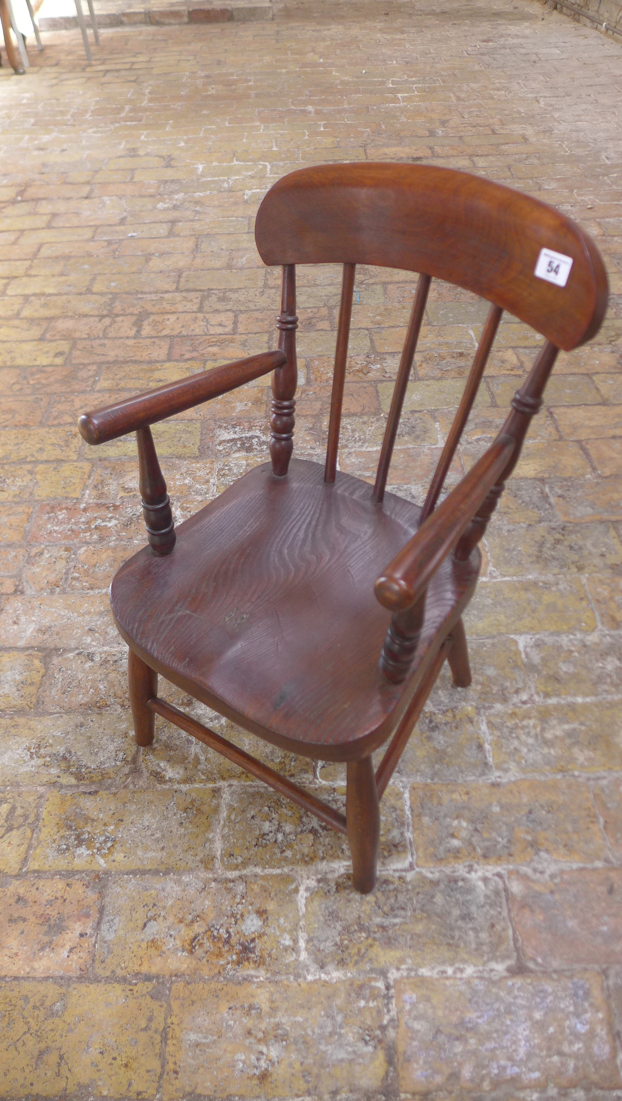 A child's ash and elm armchair, initialled SH, 64cm tall in good condition with some old traces of