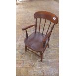 A child's ash and elm armchair, initialled SH, 64cm tall in good condition with some old traces of