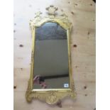 A decorative gilt mirror with eagles heads. 85cm x 39cm