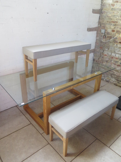 A Next oak glass top dining table and 2 grey leather effect stools, table 75 cm tall x 200 cm x 90