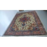A hand knotted woolen Heriz rug - 3.44m x 2.80m - in good condition, some colour variation to border