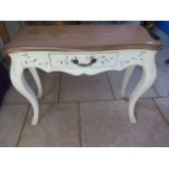 A painted side table with a shaped top, 78 cm tall x 95 cm x 39 cm