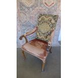 An 18/19th century walnut open armchair with scroll arms and shaped legs. Solid but has age
