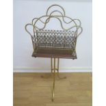 An oak and brass revolving magazine rack. 77cm tall x 39cm. In good condition.