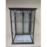 A mahogany shop counter top display cabinet lettered Rowntrees Chocolates with two sliding doors and