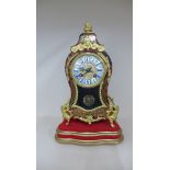 A French Boulle mantle clock with ormolu mounts on a gilt stand 36cm tall, striking on a bell,