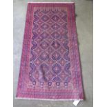 A hand knotted Baluchi rug. Size 1.6m x 0.83m