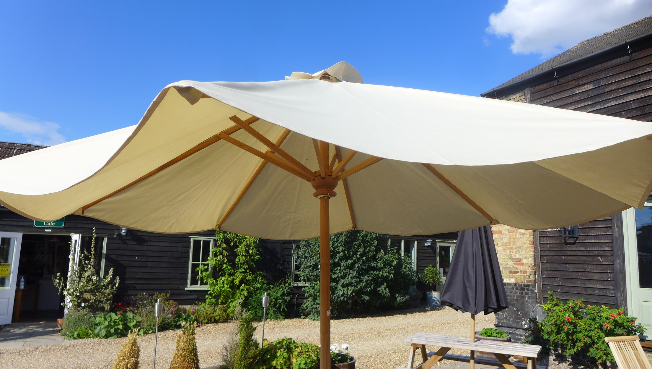 A garden parasol and concrete base 3m