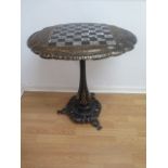 A Victorian papier mache and mother of pearl tilt top sidetable with a chess board top, stamped