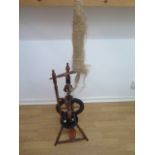 A 19th century fruitwood spinning wheel 124cm tall with nice colour and patina