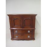 A 19th century style miniature mahogany cupboard over chest 44cm tall, 42 x 23cm in good condition.