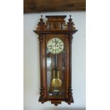 A Gustav Becker twin weight walnut wallclock with 8 day movement. Running in saleroom, 130cm tall