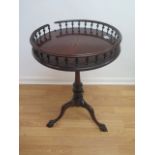 A mahogany wine table with a star inlaid galleried top, tilting birdcage action on a carved tripod