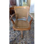 An Oak upholstered revolving desk chair