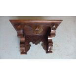 A oak Gothic wall bracket shelf, 25cm tall x 43cm x 27cm