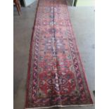 A hand knotted Hamadan rug. Size 3.82m x 1m