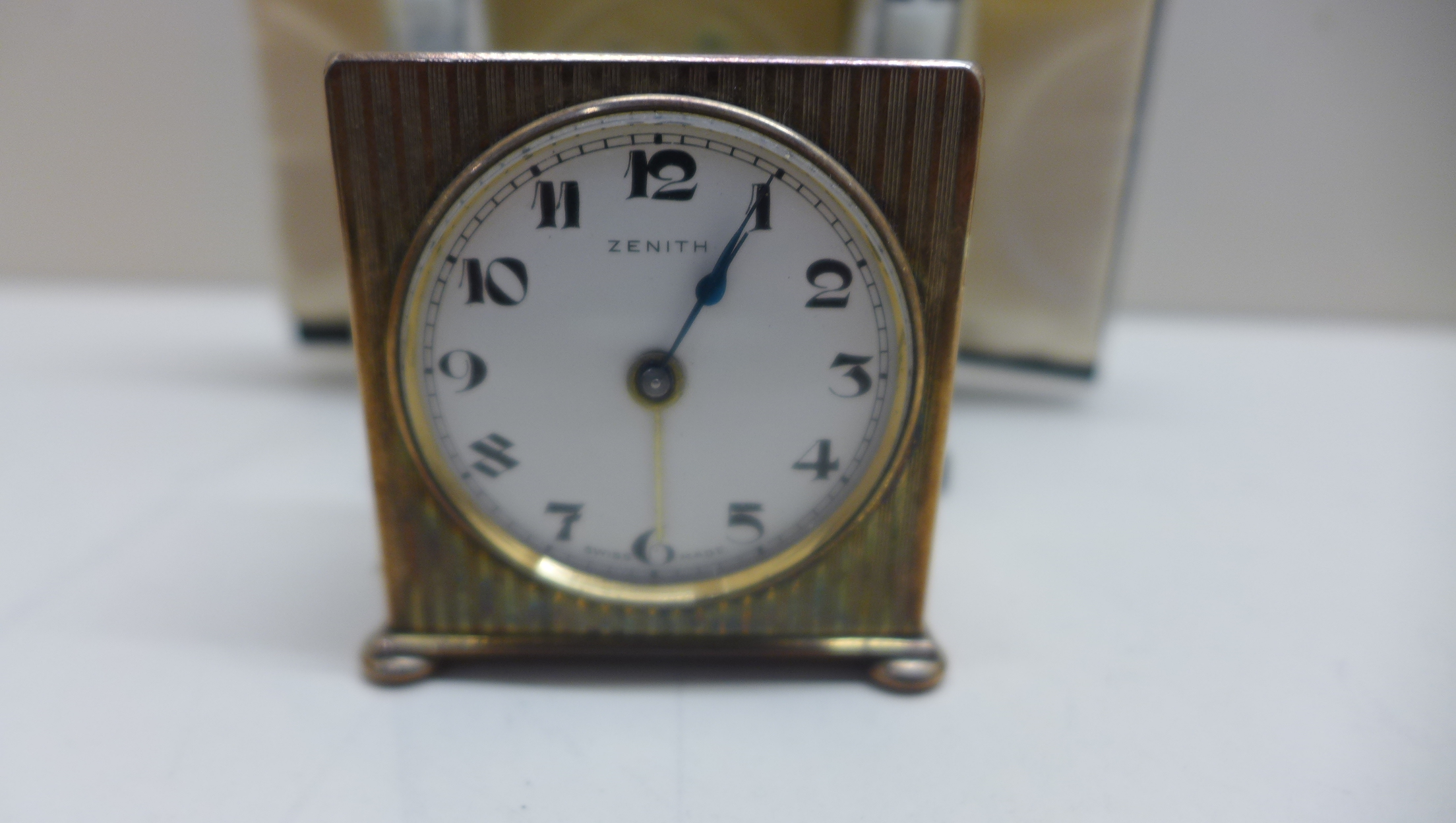 A Zenith travel alarm clock with outer case with a 4cm dial, running in saleroom. - Image 2 of 3
