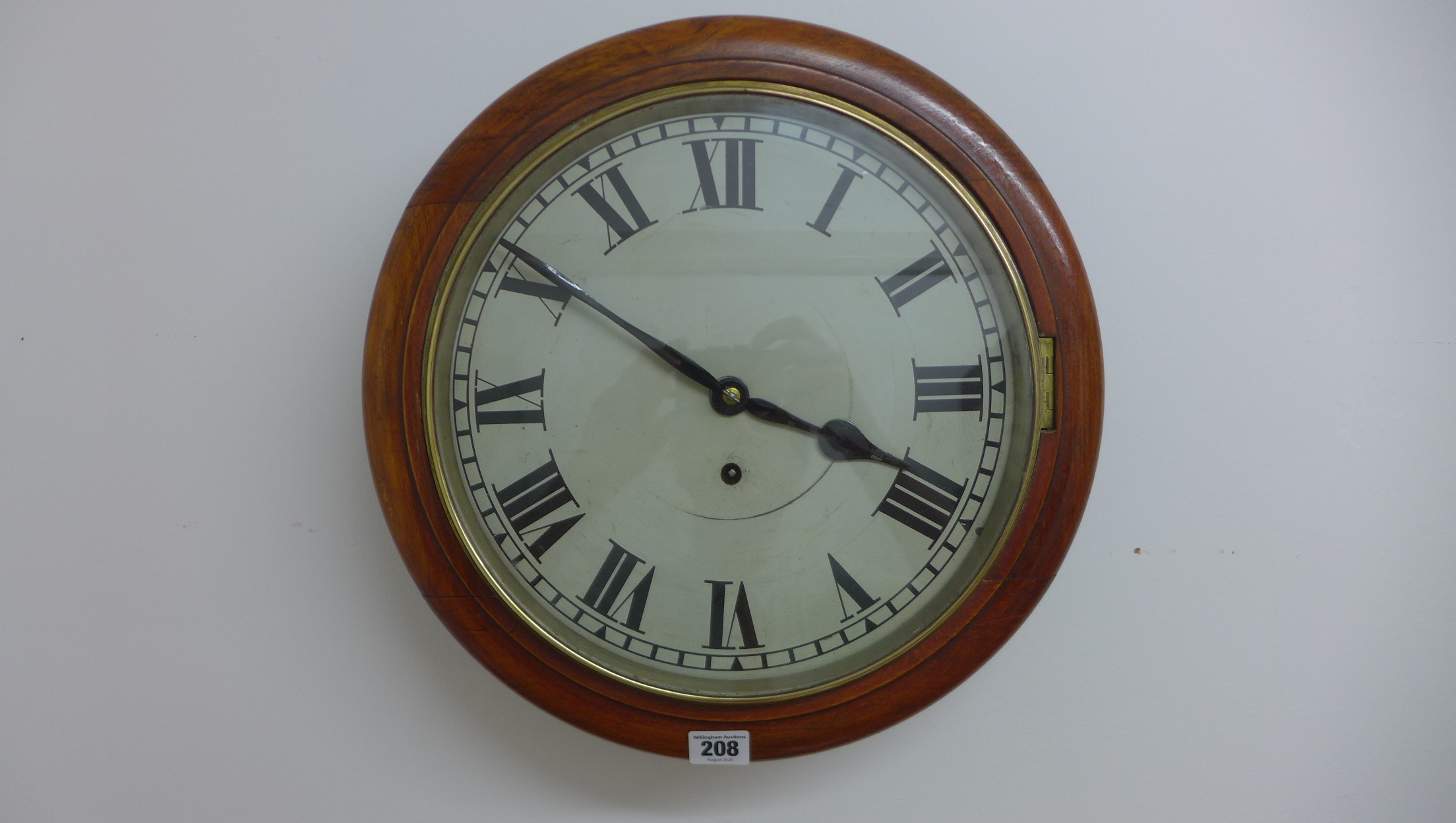 A 12 inch dial spring drive wallclock, brass bezel ,oak surround - running