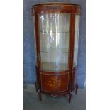 A 20th century bowfronted continental vitrine display cabinet with ormulu mounts and 2 glass