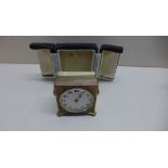 A Zenith travel alarm clock with outer case with a 4cm dial, running in saleroom.