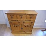 A new pine school-type chest with 5 itemised drawers above 2 cupboard doors 79cm tall, 77 x 30cm