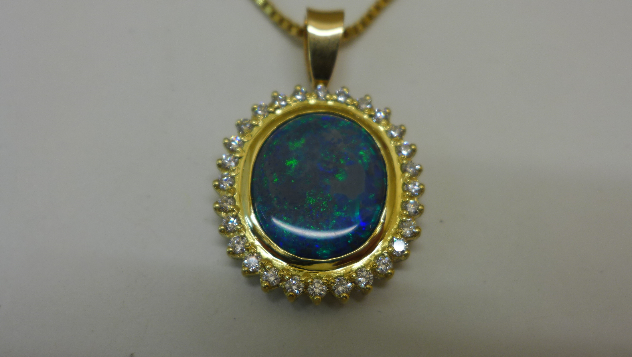 A reversible black opal and diamond pendant set in 18ct yellow gold on an 18ct chain, chain length - Image 2 of 4