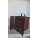 A chinese red lacquer travelling brush box with two doors enclosing 6 drawers, 36 x 19cm with